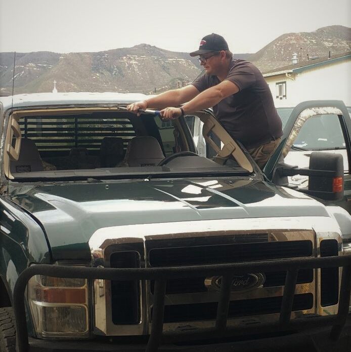 Technician performing auto glass repair in Durango CO