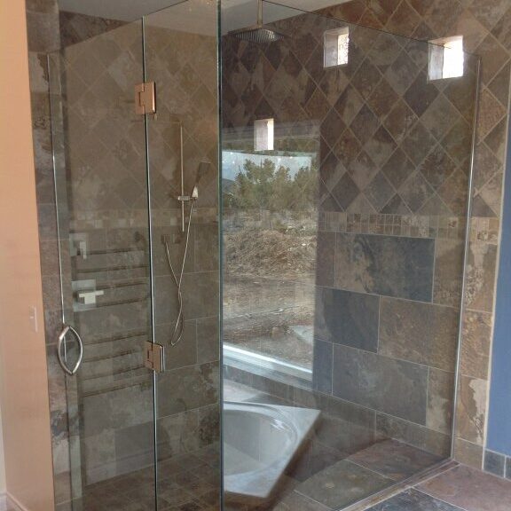 Frameless custom shower glass enclosure installed in Mancos Colorado home