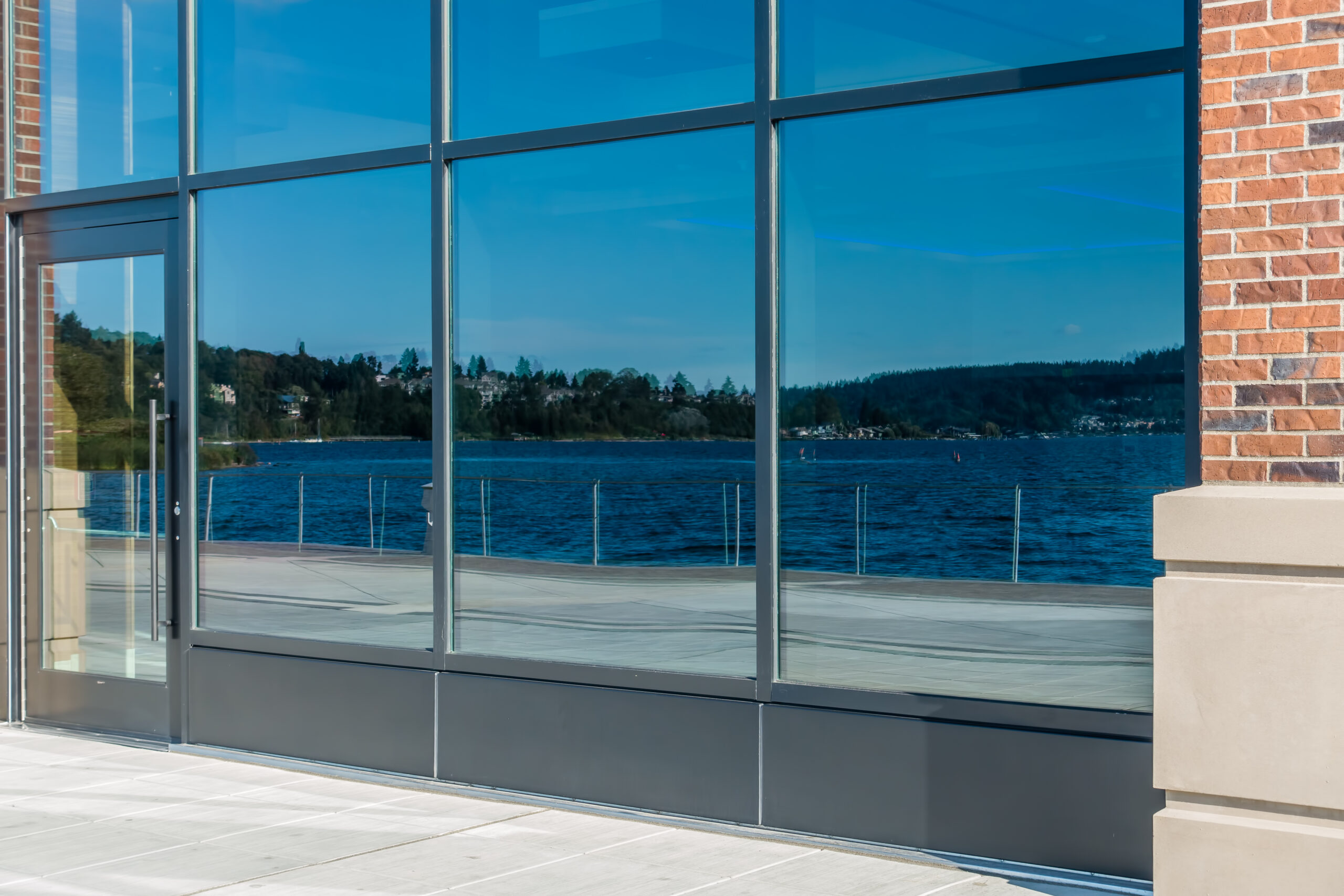 Modern commercial storefront glass entrance installed on a retail business building.